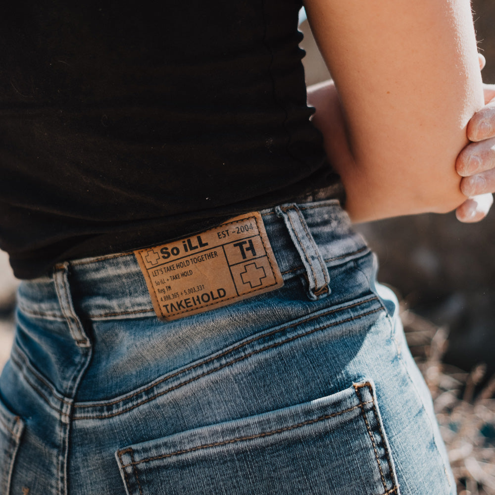 woman posing in vintage wash denim so ill climbing jeans