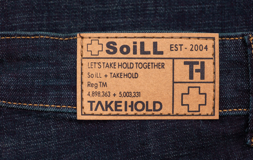 close up detail of so ill denim jeans tag